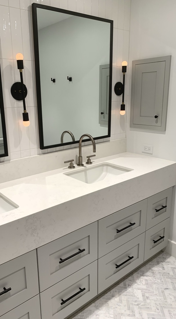 Custom bathroom vanity with a marble countertop and black hardware, San Diego